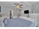 Cozy main bedroom featuring a ceiling fan, TV, and a dresser for optimal comfort and convenience at 231 Grindstone Dr, Apex, NC 27502
