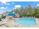 Community pool with clear blue water and lounge chairs, perfect for relaxing and enjoying sunny days at 231 Grindstone Dr, Apex, NC 27502