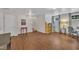 Spacious room with wood flooring, offering versatile space and natural light with easy access to stairs at 231 Grindstone Dr, Apex, NC 27502