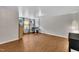 Versatile room with wood flooring, offering ample space and natural light, ideal for a home office or den at 231 Grindstone Dr, Apex, NC 27502