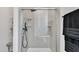 Modern shower with black hardware, glass doors, and tile walls, adding a touch of luxury to the bathroom at 231 Grindstone Dr, Apex, NC 27502