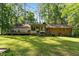 Large backyard featuring a deck, lawn, and plenty of trees at 2410 Overbrook Ln, Sanford, NC 27330