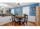 Dining room with modern décor featuring dark wood table, hardwood floors and abundant light at 2410 Overbrook Ln, Sanford, NC 27330