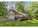 Exterior view of home featuring a large yard, garage, and deck at 2410 Overbrook Ln, Sanford, NC 27330