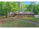 Charming brick ranch home with a well-maintained front yard and a walkway through mature trees at 2410 Overbrook Ln, Sanford, NC 27330