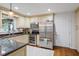 Well-lit kitchen with stainless steel appliances, granite countertops, and traditional cabinetry at 2410 Overbrook Ln, Sanford, NC 27330