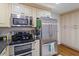 Cozy kitchen with stainless steel appliances, granite countertops, and light cabinetry at 2410 Overbrook Ln, Sanford, NC 27330