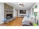 Cozy living room with a stone fireplace, hardwood floors, and natural light at 2410 Overbrook Ln, Sanford, NC 27330