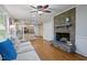 Inviting living room with stone fireplace, hardwood floors, and an open floor plan to the kitchen at 2410 Overbrook Ln, Sanford, NC 27330