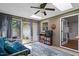 Sunroom with skylights, comfortable seating, access to outdoor area and a brick wall at 2410 Overbrook Ln, Sanford, NC 27330