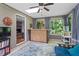 Bright sunroom featuring tile floors, ceiling fan, skylight, and view of the backyard at 2410 Overbrook Ln, Sanford, NC 27330