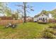 A backyard with chairs around a fire pit and a small deck that create inviting relaxation spots at 2508 Albany St, Durham, NC 27705