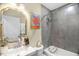 Stylish bathroom featuring a shower-tub combination with gray tiles and a white sink vanity at 2508 Albany St, Durham, NC 27705