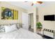 A cozy bedroom with a queen-sized bed, an indoor plant, and a wall-mounted television at 2508 Albany St, Durham, NC 27705