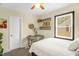A well-lit bedroom with decorative shelving, artwork, and a comfortable bed at 2508 Albany St, Durham, NC 27705