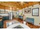 An open-concept kitchen and dining area with stainless steel appliances and hardwood floors at 2508 Albany St, Durham, NC 27705