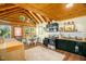 A full view of the kitchen with stainless steel appliances, and a unique wooden ceiling at 2508 Albany St, Durham, NC 27705