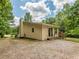 Back exterior view of the home showcasing the deck and siding with a sloped yard at 280 Sagamore Dr, Louisburg, NC 27549