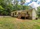 An image capturing the house's backyard, complete with a wooden deck and fenced perimeter at 280 Sagamore Dr, Louisburg, NC 27549