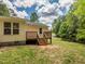 An image showcasing the backyard, featuring a small wooden deck, ideal for peaceful relaxation at 280 Sagamore Dr, Louisburg, NC 27549
