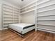 Bedroom features hardwood floors and a built-in murphy bed with shelving at 280 Sagamore Dr, Louisburg, NC 27549