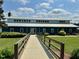 Exterior of clubhouse featuring a concrete walkway and lush greenery at 280 Sagamore Dr, Louisburg, NC 27549