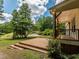 Side view of the wooden deck and porch with black railing on a bright day at 280 Sagamore Dr, Louisburg, NC 27549