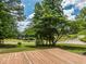 The property features a large tiered deck with views of the lake and verdant surroundings at 280 Sagamore Dr, Louisburg, NC 27549
