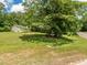 Inviting home exterior surrounded by mature trees and well-maintained grassy lawn at 280 Sagamore Dr, Louisburg, NC 27549