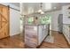 Kitchen featuring a wooden island, granite countertops, a farmhouse sink, stainless steel appliances and backyard access at 280 Sagamore Dr, Louisburg, NC 27549