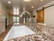 Close up of a granite countertop with a stainless steel faucet and kitchen view including a sliding barn door at 280 Sagamore Dr, Louisburg, NC 27549