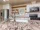 Close up of a bright kitchen with stainless steel appliances, granite countertops, and a subway tile backsplash at 280 Sagamore Dr, Louisburg, NC 27549