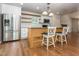 An open kitchen with stainless steel appliances, granite countertops, a wooden island and two barstools at 280 Sagamore Dr, Louisburg, NC 27549