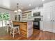 Spacious kitchen featuring a wooden island, barstools, stainless steel appliances, and plenty of cabinet space at 280 Sagamore Dr, Louisburg, NC 27549