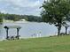 Lake view featuring shaded picnic pavilions; ideal spot to relax and enjoy the waterfront scenery at 280 Sagamore Dr, Louisburg, NC 27549