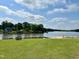 Beautiful lake view with green grass, sandy beach and lake access for residents at 280 Sagamore Dr, Louisburg, NC 27549