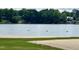 Beautiful lake view with a sandy beach area, perfect for swimming and recreation at 280 Sagamore Dr, Louisburg, NC 27549