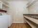 Functional laundry room with washer, dryer, granite countertop and storage shelving at 280 Sagamore Dr, Louisburg, NC 27549