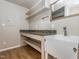 Functional laundry room featuring granite countertops, a utility sink, a vanity mirror and storage shelves at 280 Sagamore Dr, Louisburg, NC 27549