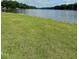 Well-maintained lawn with scenic views of the lake and surrounding greenery at 280 Sagamore Dr, Louisburg, NC 27549