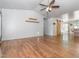 Open living room featuring hardwood floors, a ceiling fan, a sliding barn door and two wooden shelves at 280 Sagamore Dr, Louisburg, NC 27549