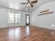 Bright living room featuring a vaulted ceiling, hardwood floors, and a sliding glass door to the outside at 280 Sagamore Dr, Louisburg, NC 27549