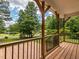 Exterior image of the wooden porch with black railings and a view of the green lawn at 280 Sagamore Dr, Louisburg, NC 27549