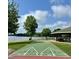 Community shuffleboard court and lakeside picnic shelter on a sunny day with beautiful cloudscape above at 280 Sagamore Dr, Louisburg, NC 27549