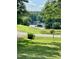Picturesque view of the lake showcasing a grassy area with a boat in the foreground at 280 Sagamore Dr, Louisburg, NC 27549
