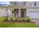 Cozy front porch featuring stone columns, rocking chairs, and manicured landscaping for added curb appeal at 3019 Britmass Dr, Raleigh, NC 27616