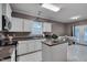 Bright kitchen with white cabinetry, a center island, and modern appliances, creating a functional space at 3019 Britmass Dr, Raleigh, NC 27616