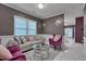 Comfortable living room featuring a modern sofa, and large windows, perfect for relaxation at 3019 Britmass Dr, Raleigh, NC 27616