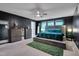 Spacious bedroom featuring a tufted headboard, dark walls, and two windows at 3019 Britmass Dr, Raleigh, NC 27616