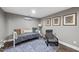 Finished basement featuring daybed, accent chair, and a window for flexible living and natural light at 309 Old Mill Village Dr, Apex, NC 27502